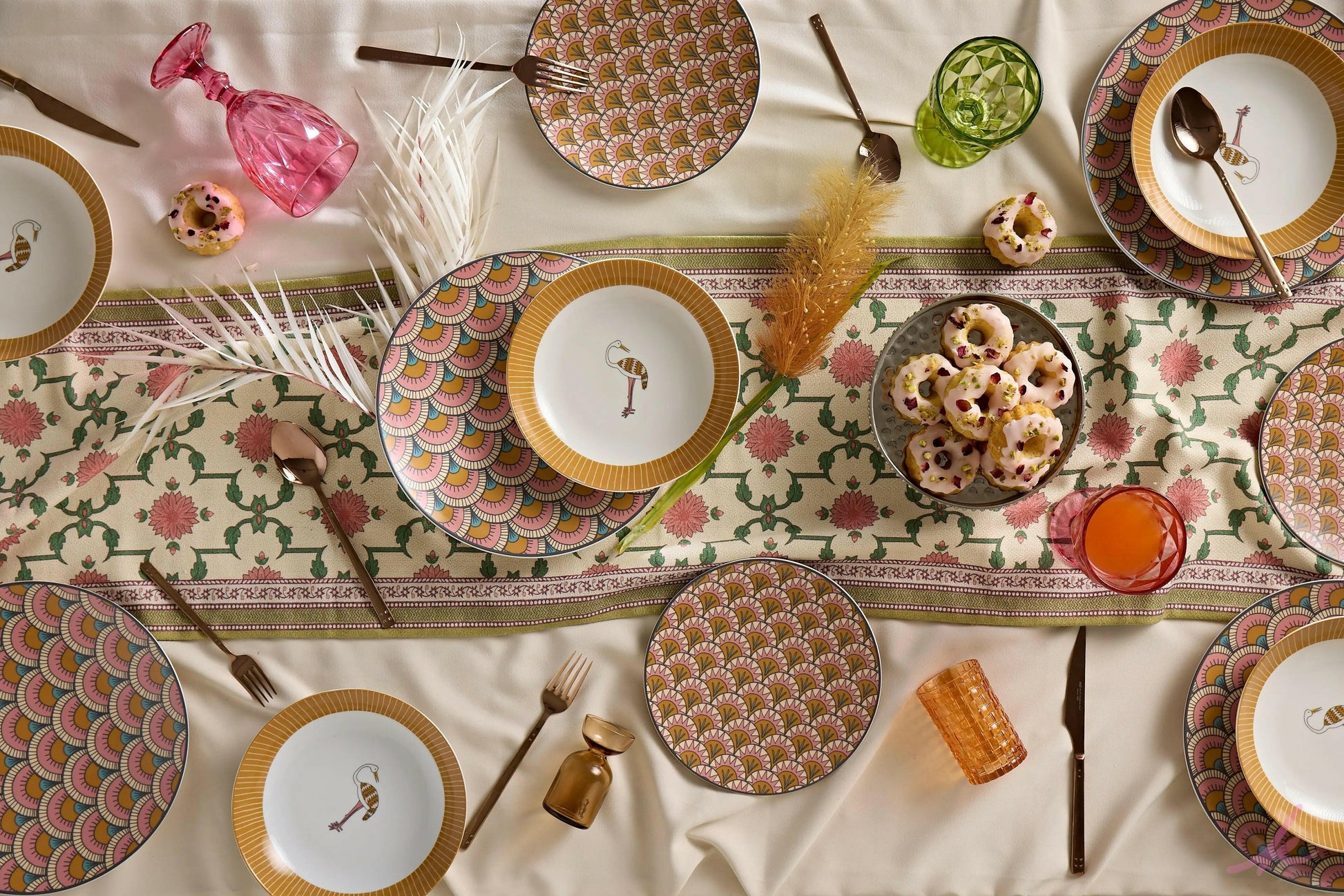 elagant dinner table set up with an ibis-themed dinnerware collection, featuring carefully arranged plates, cups, and bowls surrounded by soft lighting and natural accents.