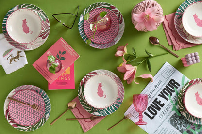 Stylish dinner table setup featuring the Leopard Set, with plates, bowls, and cups arranged in an inviting and modern aesthetic, accented by soft pink and green tones and nature-inspired decor for a sophisticated dining experience.